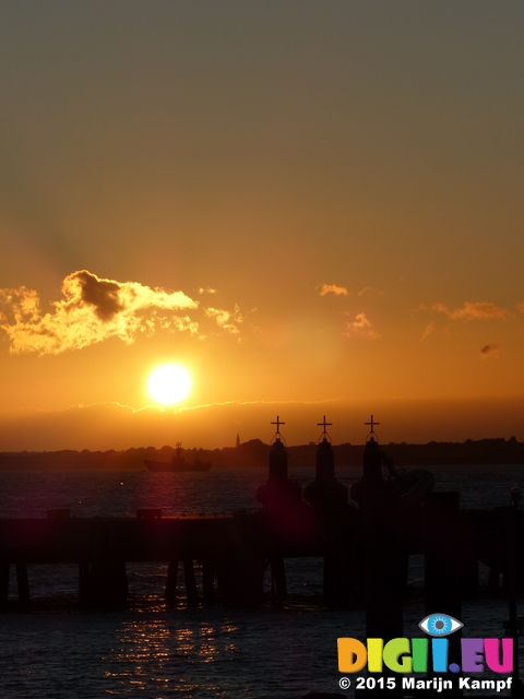 FZ019498 Sunset over lighthouse boat Harwich harbour